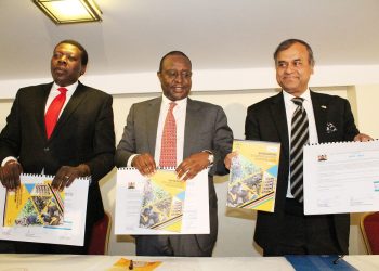 Treasury Cabinet Secretary Henry Rotich (middle), Cabinet Secretary for Devolution and ASAL Areas Eugene Wamalwa (left) and the UN Resident Representative Siddharth Chatterjee display the signed UNDAF and first year work plan during the UNDAF launch in Nairobi. www.exchange.co.tz