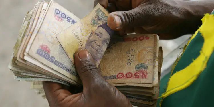 A man counting Nigerian notes :Kanu Sports Tv: Exchange
