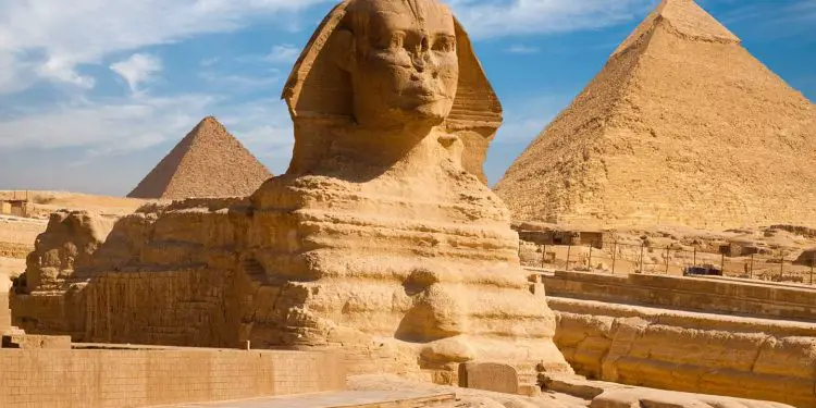 A beautiful profile of the Great Sphinx including the pyramids of Menkaure and Khafre in the background in Giza, Cairo, Egypt: World Travel Guide: Exchange