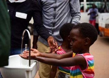 Twin sisters, Emeline and Eveline, wash their hands at a public hand washing station as a cautionary measure against the coronavirus at Nyabugogo Bus Park in Kigali, Rwanda: Reuters: Exchange