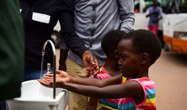 Twin sisters, Emeline and Eveline, wash their hands at a public hand washing station as a cautionary measure against the coronavirus at Nyabugogo Bus Park in Kigali, Rwanda: Reuters: Exchange