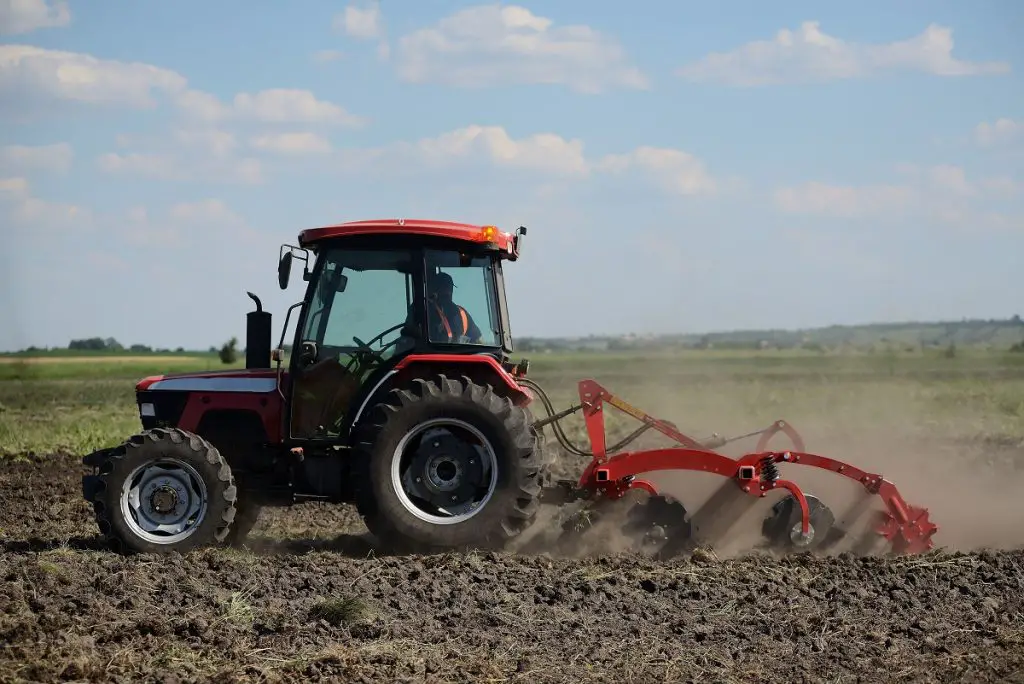 Preparing a field for planting using a tractor. Africa should embrace mechanisation which includes irrigation systems, food processing and related technologies and equipment to increase agricultural productivity. www.theexchange.africa
