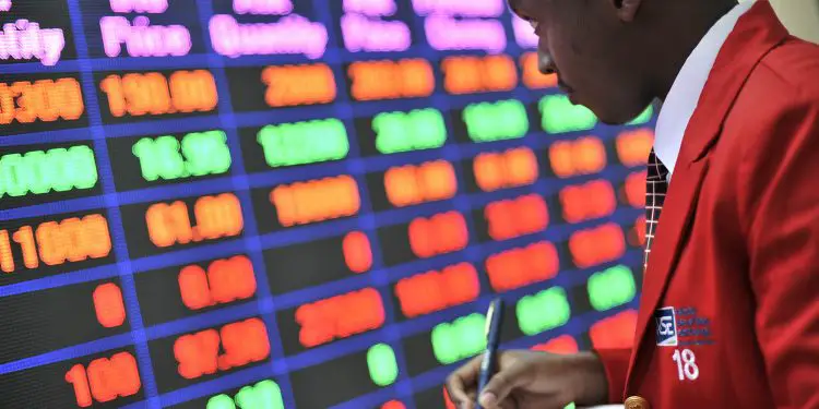 An employee makes notes in front of an electronic stock information screen inside the Nairobi Securities Exchange Ltd. (NSE),Photographer: Riccardo Gangale/Bloomberg - The Exchange