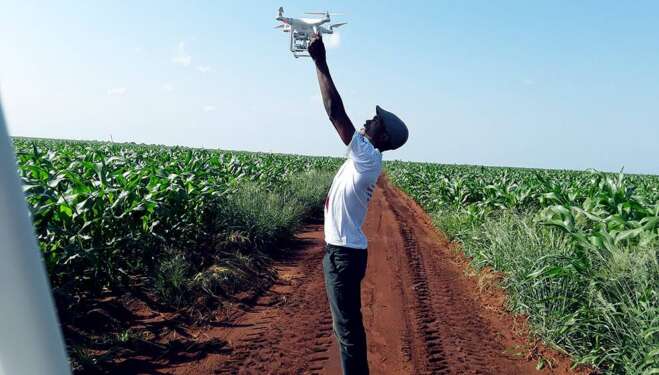 MAN USING DRONE ON FARM