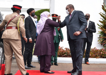 Tanzanian President Samia Suluhu Hassan and Kenyan President Uhuru Kenyatta exchange a COVID-19 elbow greeting in, Nairobi, Kenya: Photo by Millard Ayo: Exchange.