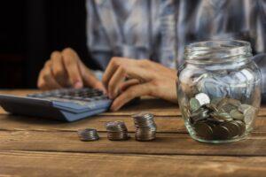 man calculating monthly savings 23 2148294829