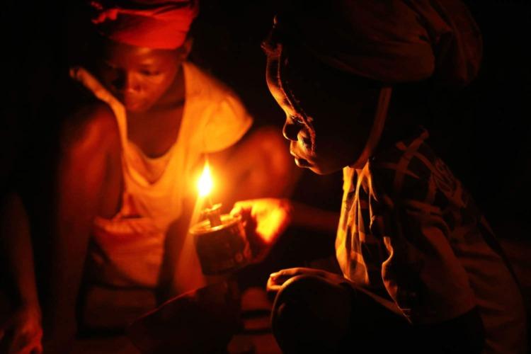 Children using a smoky lamp to study. More than 50 per cent of Sub-Saharan population is without electricity. www.theexchange.africa