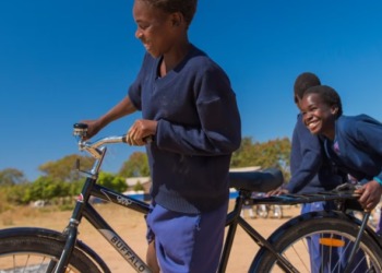 Girls learning how to ride a bike. Rural communities in Africa are especially badly hit by transport challenges. www.theexchange.africa