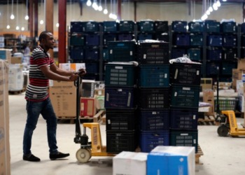 Moving goods in a warehouse. PAPSS provides Africa with greater capacity to conduct cross-border transactions and expand the scale of both active and latent opportunities for enhanced intra-African trade. www.theexchange.africa