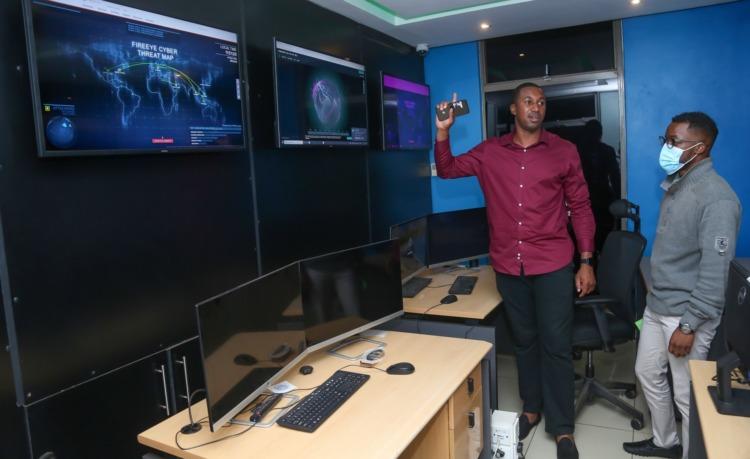 Dimension Data East and West Head of Managed Security Services Dr. Bright Mawudor (left) explains how the company monitors cyber security threats for businesses at their Threat Intelligence Centre. www.theexchange.africa