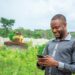 A man using a mobile phone. EWS by 4G Capital enables an early assessment of borrowers to help reduce the risk of over-indebtedness. www.theexchange.africa