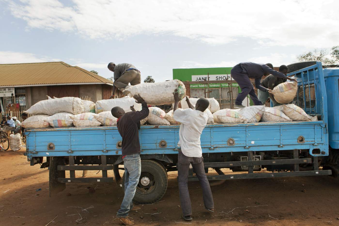 Workers loading bags of potatoes on a truck in the Nanjiri Market in Malawi. www.theexchange.africa