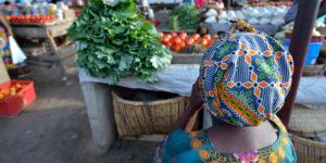 A woman with her produce in a market. AfCFTA should bring in more women to trade. www.theexchange.africa