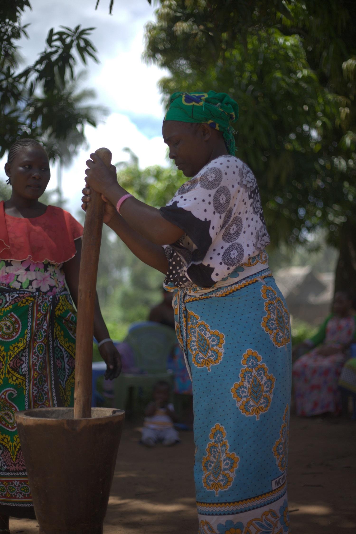 Women pounding the biochar. The women are trained to convert biomass to charcoal. www.theexchange.africa