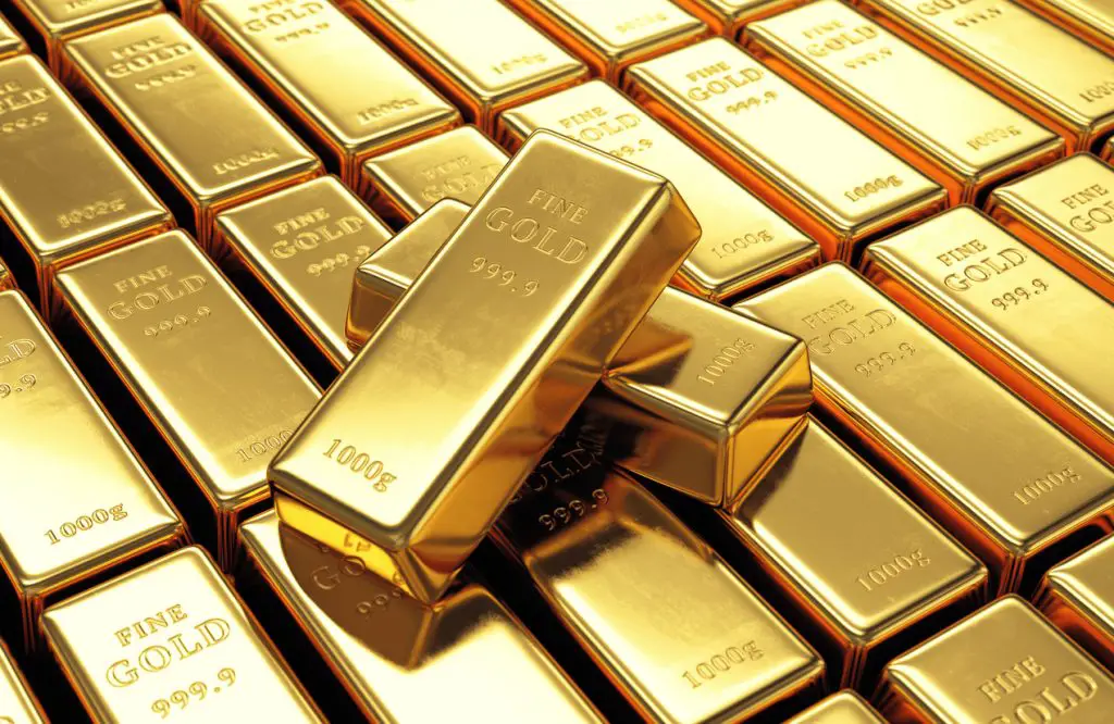 Group of gold bars with two ingots on top. Financial success, business investment and wealth concept. www.theexchange.africa