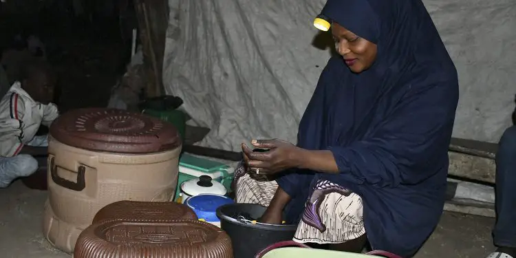 A vendor during a power supply outage in Nigeria. The West African economy must look beyond privatization to address its power problems. www.theexchange.africa