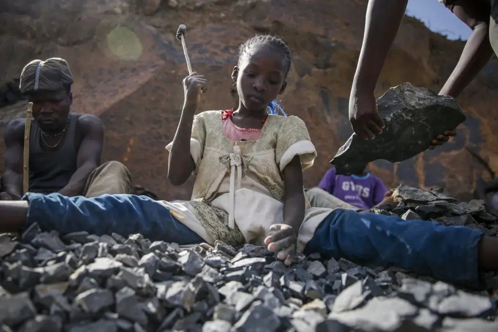A child crushing rocks to make a living. Poor Kenyans are burdened with more debts, more taxes and more hardships. www.theexchange.africa