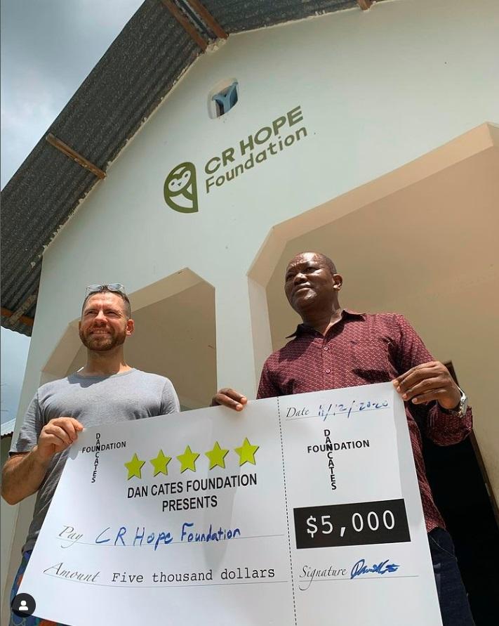 Daniel Cates with a dummy cheque for helping the CR Hope Foundation with building a school in Zanzibar. www.theexchange.africa