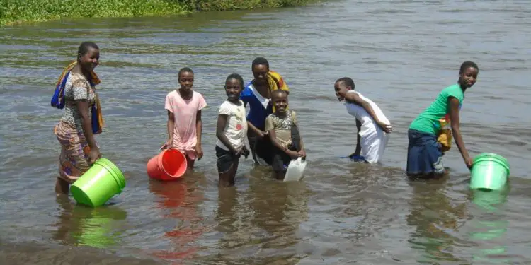 Village girls and women fetch water in a river. Lack of water affects this group the most forcing them to travel long distances in search of water. Photo/RotaryWASH