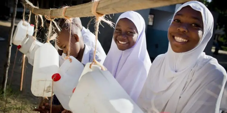 School girls wash hands using make shift water flowing taps. Photo/UNICEF