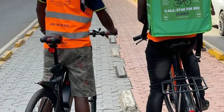 Bikers on a street in Nairobi. Improved cycling infrastructure in Kenya will help grow the gig economy while also earning the government savings on reduced accidents. www.theexchange.africa