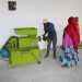Some of the group members learning the components of the new briquette making machine. The machine can produce 500 briquettes per day. www.theexchange.africa
