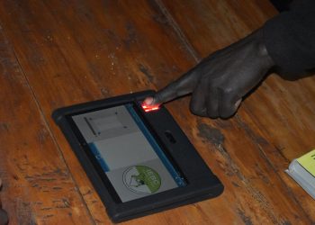 A voter places their finger for biometric identification on the KIEMS kit. Kenya's 2022 election was hailed as a success after deploying technology similar to blockchain in relaying results. www.theexchange.africa