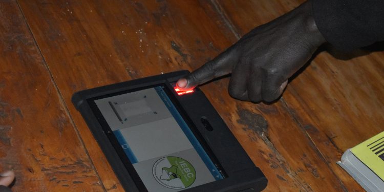 A voter places their finger for biometric identification on the KIEMS kit. Kenya's 2022 election was hailed as a success after deploying technology similar to blockchain in relaying results. www.theexchange.africa