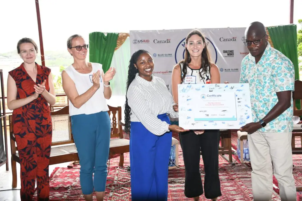 "From left to right: Gabriella Kisoi of Challenge Works and Anna Ghnouly, Environment Officer, USAID Kenya & East Africa Environment Office, hand over a certificate of recognition to H.E. Francis Foleni Thoya, Deputy Governor and CEC for Environment and Solid Waste, as he launches the finalist phase of the Mombasa Plastics Prize. The Prize, backed by USAID and the Government of Canada, and run by Challenge Works, aims to inspire young innovators to tackle marine plastic waste within the county. Also in attendance, looking on, Naomi Whitbourn of Challenge Works and Aurelia Micko, Director of USAID Kenya & East Africa Environment Office