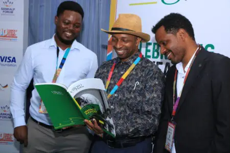 L-R Peter Awin CoFounder & CEO Cow Tibe Ghana, Dr Robert Karanja CoFounder and Chief Innovation Officer at Villgro Africa, and Habtamu Abafoge Founder Simbona Africa, Ethiopia flip through the 7 Years of Impact investment Report highlighting Villgro's input into 50 healthcare startups in Africa