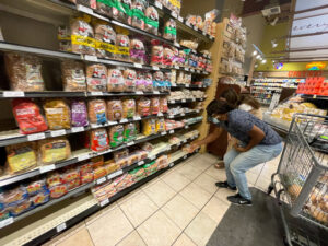 Consumer spending expected to pick up this year – report FILE PHOTO: People shop in a supermarket as rising inflation affects consumer prices in Los Angeles